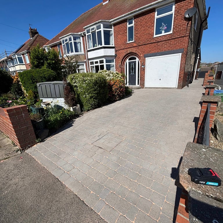 Red brick house with clean driveway
